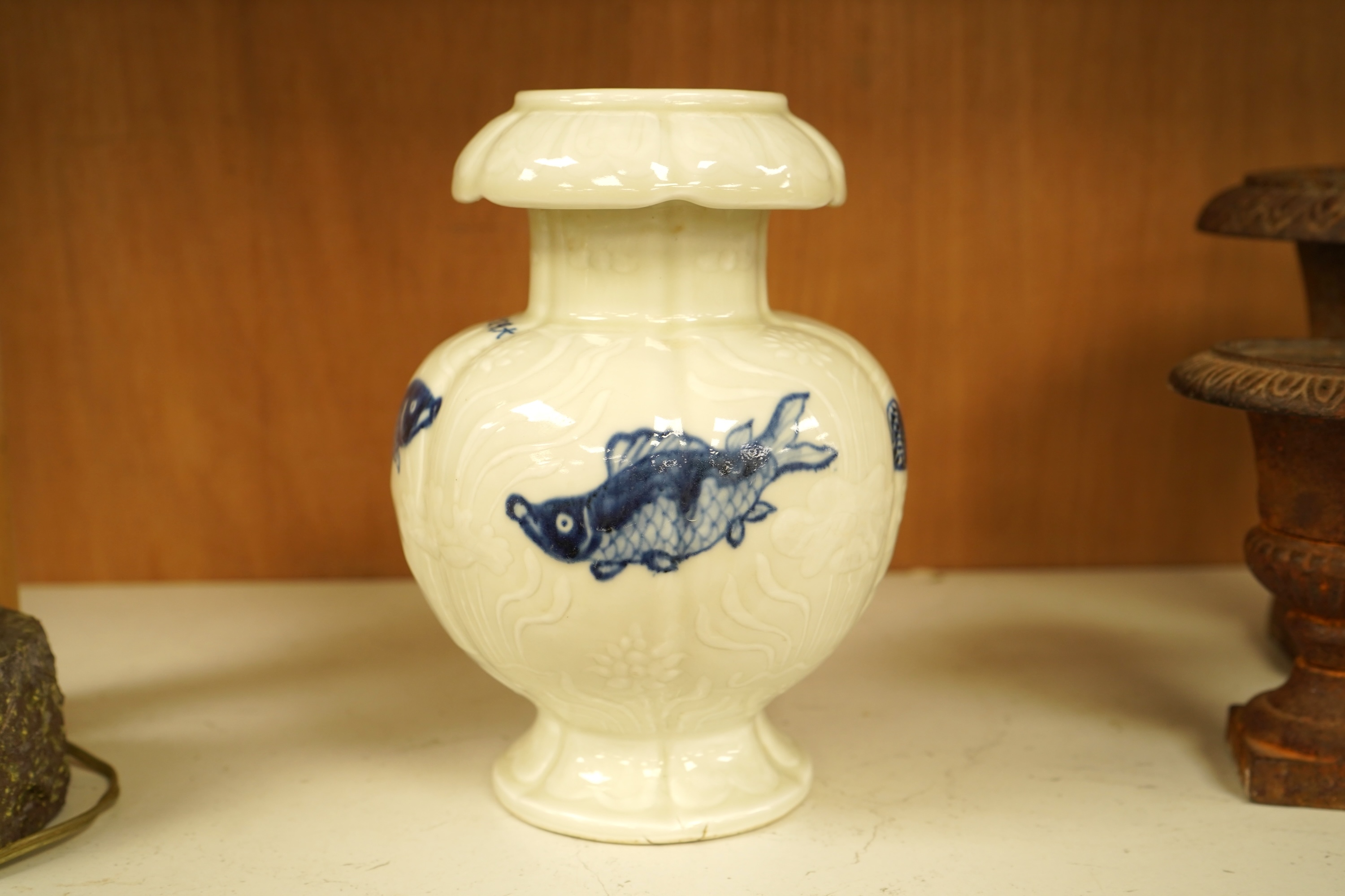 A Chinese vase decorated in low relief, hand painted with fish, 20cm high